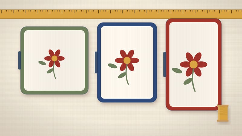 Illustration of three embroidery frames of growing size, each holding a stitched flower, above a tape measure